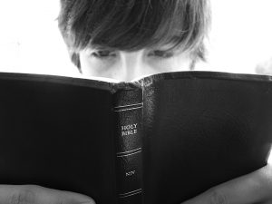 Boy read Holy Bible